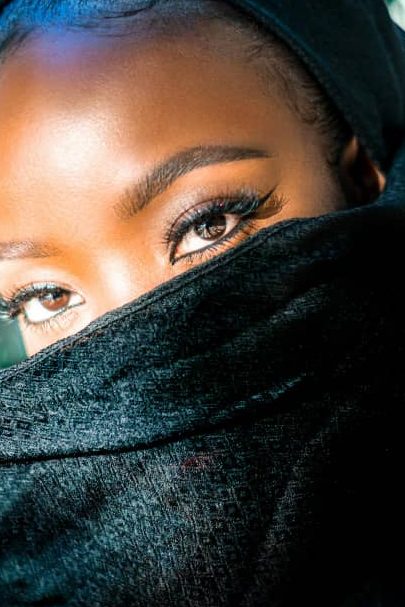 Picture showing Nigerian lady covering her face