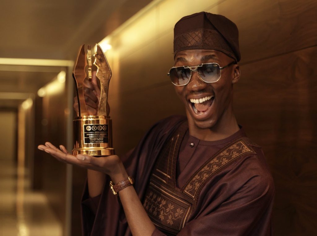 Picture showing Layi Wasabi, popular Nigerian influencer holding his award