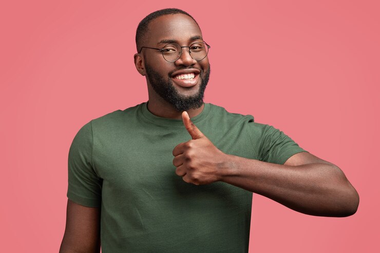 A Nigerian man smiling with his thumb up sign