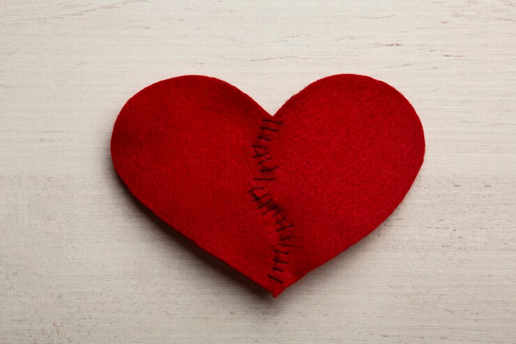 picture showing a sewn red broken heart as a sign of forgiveness 